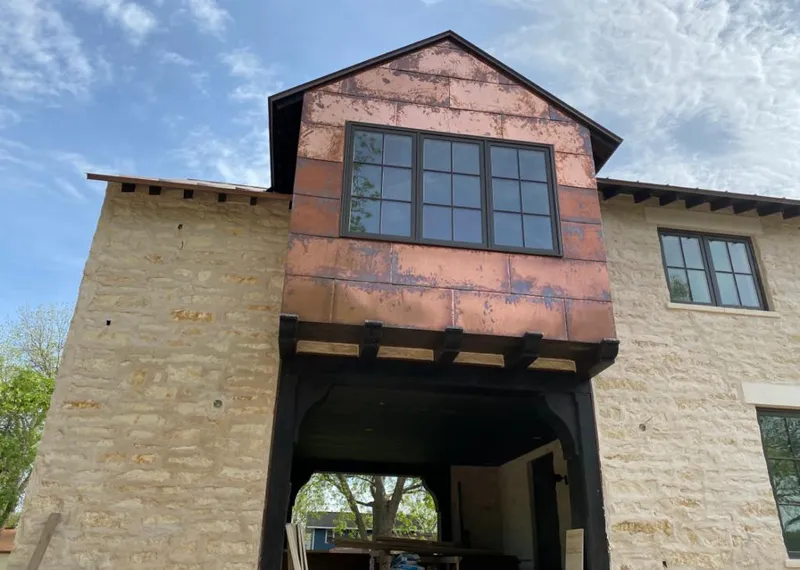 Copper metal panel facade on a stone building for Skylight Installation in Wheaton