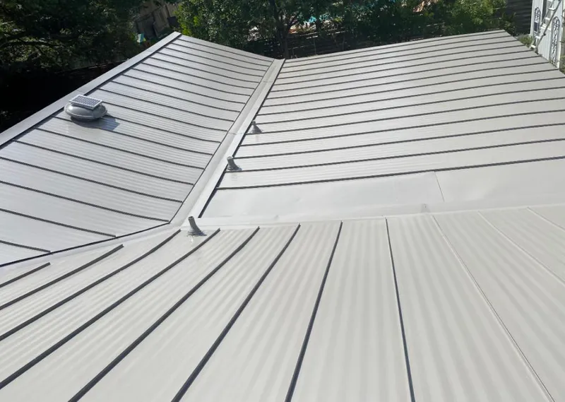 Solar attic fan installed on a metal roof for Roof Ventilation in Wheaton
